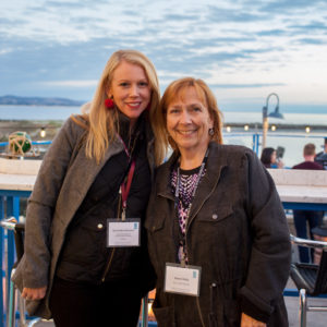 Two women smiling and posing for a photo at the FINEOS Global Summit in 2017