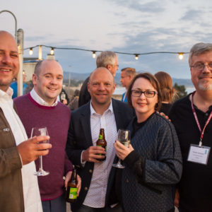 Five people posing for a photo at the FINEOS Global Summit in 2017