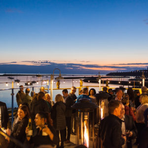 Picture of a crowd outside by a lake at FINEOS Global Summit in 2017