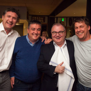 Four men smiling and posing for a photo at the FINEOS Global Summit in 2017