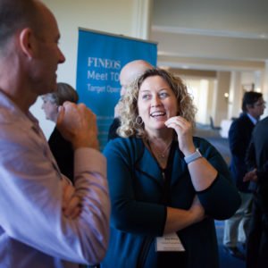 Man and woman talking at FINEOS Global Summit in 2017
